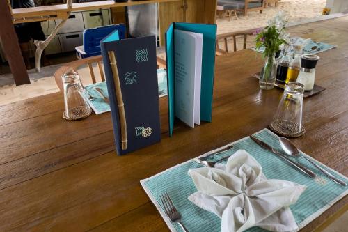a wooden table with books on top of it at Metita Beach & Dive Resort in Doruba