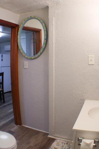 a bathroom with a mirror on the wall and a toilet at California Ave - 2 BR - Home Away from Home! in Pittsburgh