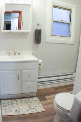 a bathroom with a white sink and a toilet at California Ave - 2 BR - Home Away from Home! in Pittsburgh