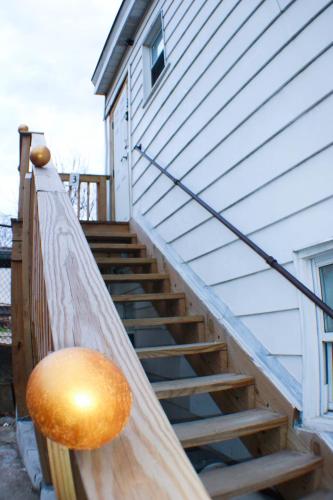 a wooden staircase leading up to a house at California Ave - 2 BR - Home Away from Home! in Pittsburgh