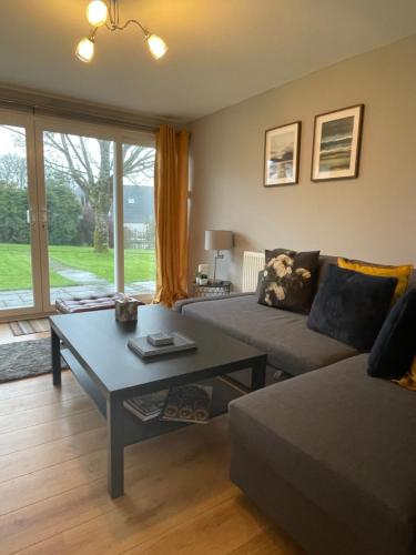 a living room with a couch and a table at Atlantic Lodge in Newquay