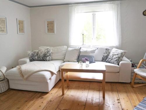 a living room with a white couch and a coffee table at 6 person holiday home in HALLABRO-By Traum in Hallabro