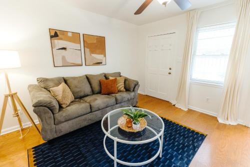 a living room with a couch and a glass table at Centrally Located 2BR Overton Square Unit 2 Fast WiFi Free Parking Yes Pets in Memphis