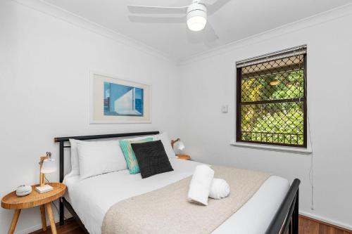 a white bedroom with a bed and a window at 22 Heavenly Highgate New 2br Parkinghbf in Perth