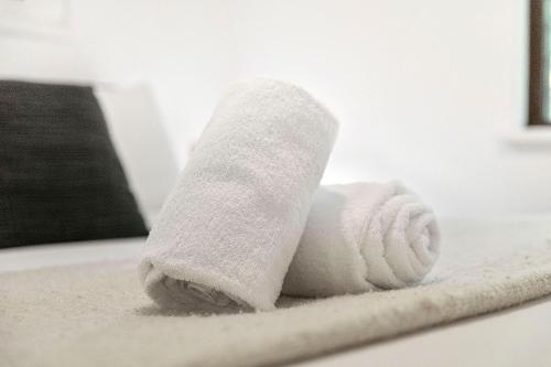 a white towel sitting on top of a bathroom rug at 22 Heavenly Highgate New 2br Parkinghbf in Perth