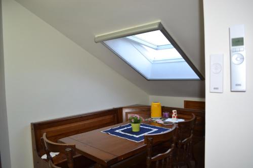 a dining room with a table and a skylight at A Pochi Passi in Venaria Reale
