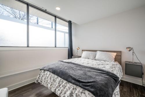 a bedroom with a bed and a large window at Modern Contemporary 2 Bedroom Suite in Halifax