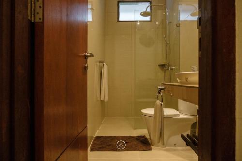 a bathroom with a shower and a toilet and a sink at Cempaka 1 Villa 5 bedroom with a private pool in Bandung