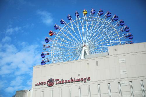 a ferris wheel sitting on top of a building at HOTEL MYSTAYS Matsuyama in Matsuyama