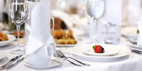a table with a plate with a strawberry on it at Hotel Vista Mare & Spa - Aperto tutto l'anno in Cesenatico