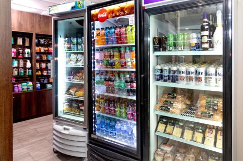 a refrigerator filled with lots of different types of drinks at Red Roof PLUS Miami Airport in Miami