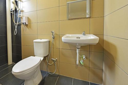 La salle de bains est pourvue de toilettes et d'un lavabo. dans l'établissement 4S Hotel, à Muar