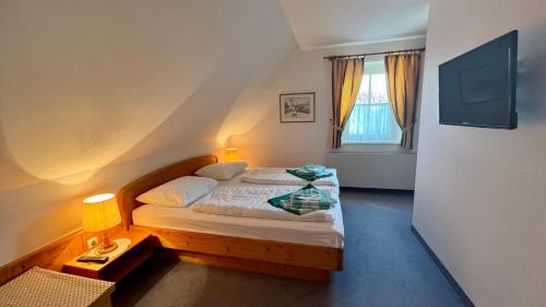a small bedroom with a bed and a window at Apartment in Bad Waltersdorf - Steiermark 44009 in Bad Waltersdorf