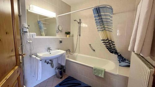 a bathroom with a sink and a bath tub and a sink at Apartment in Bad Waltersdorf - Steiermark 44009 in Bad Waltersdorf