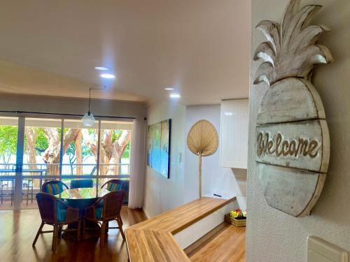 a kitchen and dining room with a table and chairs at BeachView Apartments at Villa Paradiso in Palm Cove