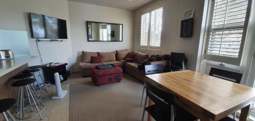 a living room with a couch and a table at Beehive 18 in Mount Buller