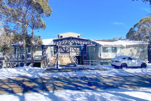 a car parked in front of a house in the snow at Elkhorn 17 - Mt Buller Village in Mount Buller