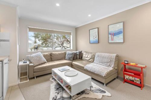 a living room with a couch and a table at Elkhorn 17 - Mt Buller Village in Mount Buller