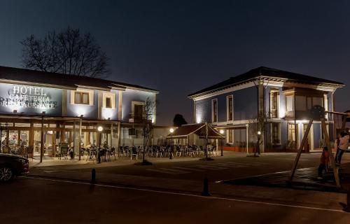 a building with a lot of tables in front of it at Hotel Villa Maria in Revilla de Camargo