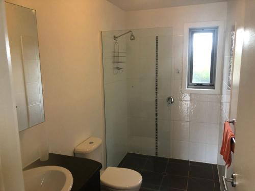a bathroom with a shower and a toilet and a sink at Stirling View in Merrijig