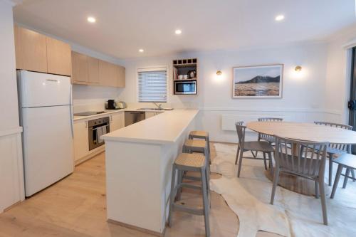 a kitchen and dining room with a table and chairs at Disco 7 in Mount Buller