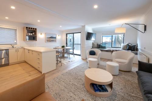 a kitchen and living room with a couch and a table at Disco 7 in Mount Buller