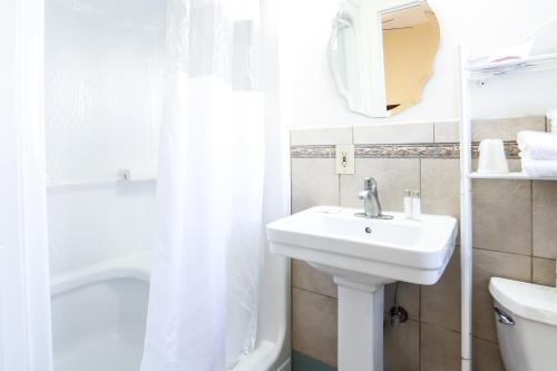 a bathroom with a sink and a toilet and a shower at The Hotel Hollywood in Los Angeles