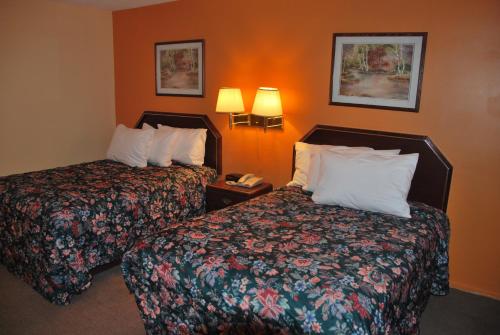 um quarto de hotel com duas camas e um telefone em Imperial Motel Cortland em Cortland