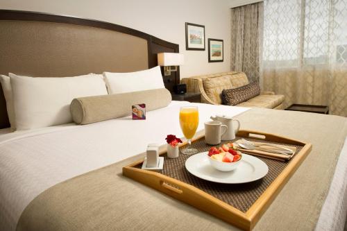 a hotel room with a tray of food on a bed at Crowne Plaza Seattle Airport, an IHG Hotel in SeaTac