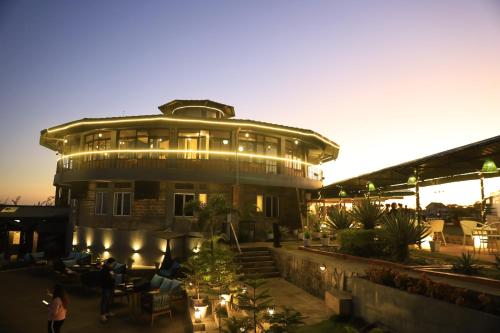 a large building with people standing in front of it at Polo Cherrapunjee Resort in Cherrapunji