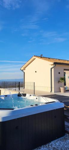 a hot tub in a yard next to a building at Villa TonKa with jacuzzi sauna and private pool in Labin