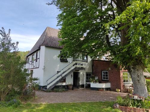 an exterior view of a house with a staircase at Reiterhof Bökensberg in Kasseedorf
