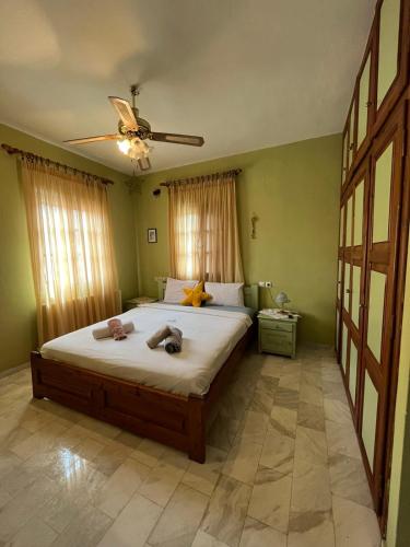 a bedroom with a bed with two towels on it at Valenthia in Agios Ioannis Pelio