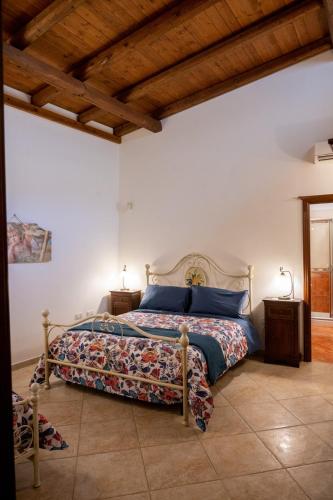 a bedroom with a bed in a room with wooden ceilings at Corcioli B&B in Mesagne
