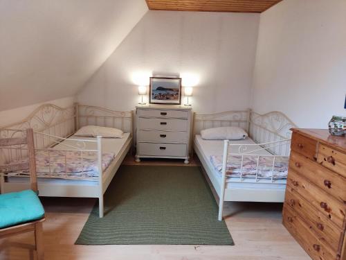 a bedroom with two bunk beds and a tv at Reiterhof - Welsh Cob Gestüt in Kasseedorf