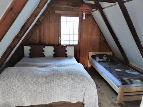 a bedroom with two beds in a attic at Chata Kubíček na Šumavě in Prachatice