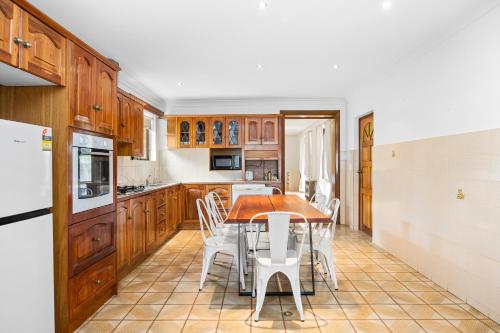 a kitchen with a table and chairs in it at Swainson on Margaret in Oaklands