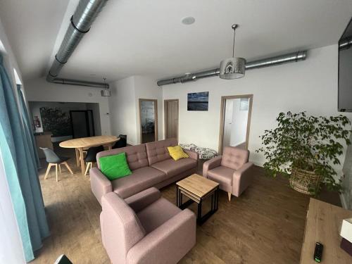 a living room with a couch and a table at Siesta in Grzybowo