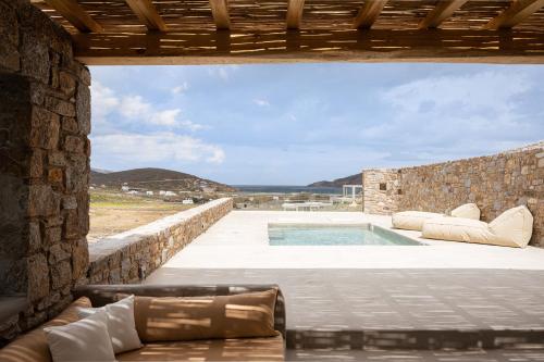 a view from the patio of a house with a swimming pool at Koumi Homes Mykonos in Elia
