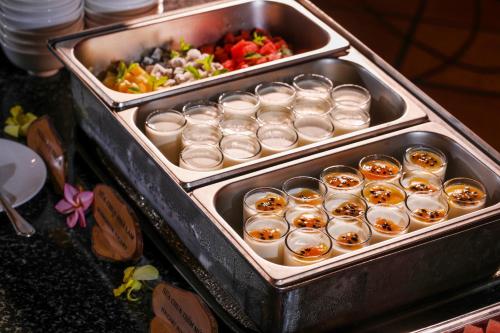 a tray of cupcakes and a bunch of food at Victoria Nui Sam Lodge in Chau Doc