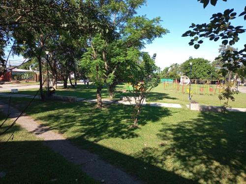 a park with a playground with trees and grass at Aires del Cerro in Yerba Buena