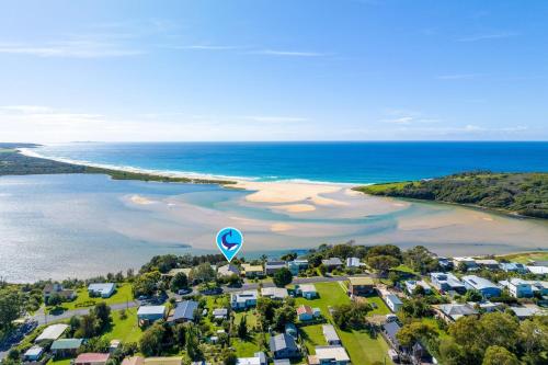 an aerial view of a beach with a hot air balloon at Lake View Luxury Wallaga Lake - 21 Lakeview Drive in Tilba Tilba