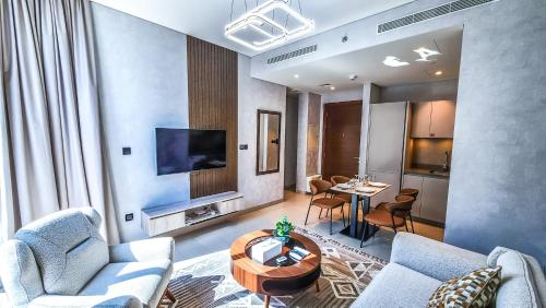 a living room with a couch and a table at STAY BY LATINEM Luxury 1BR Holiday Home CVR A3002 near Burj Khalifa in Dubai