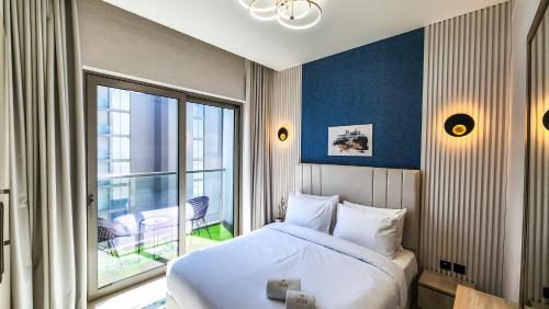 a bedroom with a bed and a large window at STAY BY LATINEM Luxury 1BR Holiday Home CVR A3002 near Burj Khalifa in Dubai