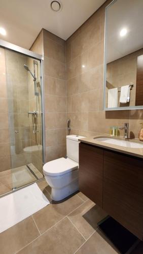a bathroom with a toilet and a shower and a sink at STAY BY LATINEM Luxury 1BR Holiday Home CVR A3002 near Burj Khalifa in Dubai
