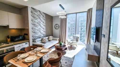 a kitchen and living room with a table and chairs at STAY BY LATINEM Luxury 1BR Holiday Home CVR A3002 near Burj Khalifa in Dubai