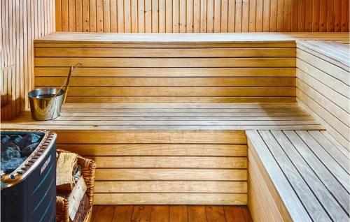 a wooden sauna with a bucket in the middle at Nice Apartment In Oskarshamn With Wifi in Oskarshamn