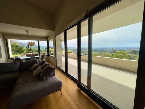 a living room with a couch and large windows at Soleada in Gijón