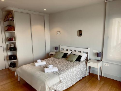 a bedroom with a bed with two towels on it at Soleada in Gijón