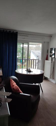 a living room with a couch and a table at Bel Cabourg in Cabourg